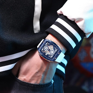 Detail of blue dial multifunctional quartz watch with white silicone strap on wrist