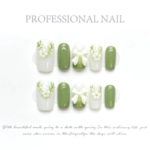 Detailed view of handmade press-on nails with 3D petals, bows, and green gradient effects