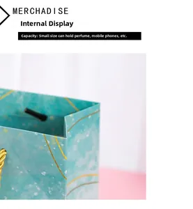 Small mint green gift bag with gold sand pattern showing interior perfume capacity