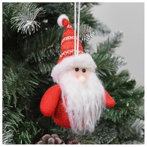 Close-up of a plush Santa Claus ornament with white beard hanging on a Christmas tree