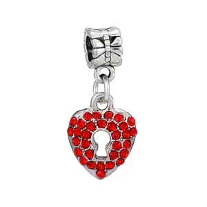 Macro shot of silver heart charm with red rhinestones and keyhole detail for bracelets