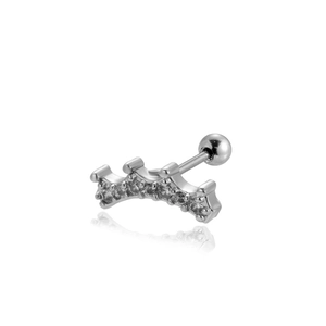 Macro shot of silver crown barbell earring with sparkling cubic zirconia on white surface