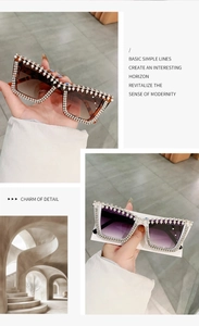 Detail of oversized square sunglasses with sparkling rhinestones and pearl embellishments