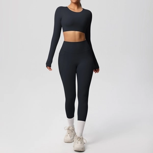 Detail view of navy blue high-stretch yoga set with long sleeve crop top and side pocket leggings