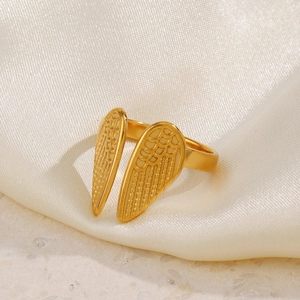 Vintage 18K gold plated stainless steel angel wing open ring on silk background