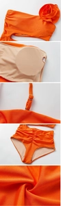 Detail of 3D rose ornament, adjustable buckle, and high-waist ruched texture on orange swimsuit