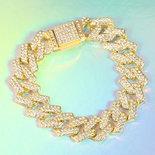Detail of gold Cuban link bracelet with pavé rhinestones and square buckle clasp