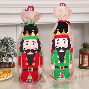Detail of red and green nutcracker wine bottle covers in festive linen fabric material