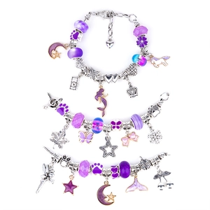 Detailed top view of three purple ocean-themed charm bracelets with star and moon pendants