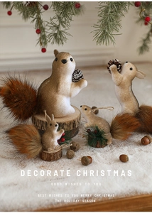 Detailed view of artificial foam squirrels with pine cones in a snowy festive scene