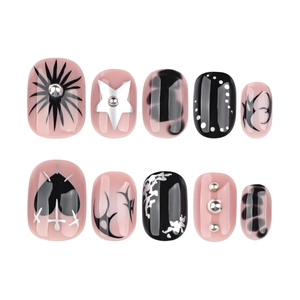 Y2K gothic press-on nails featuring black hearts, silver stars, and 3D metallic studs