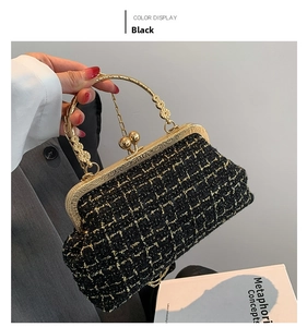 Detail of black tweed crossbody bag with gold embossed handle and metal chain