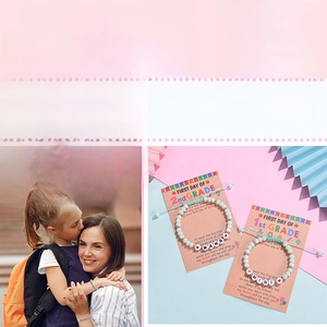 Close-up of Mama and Mini beaded bracelets on a themed school gift card for mother and daughter