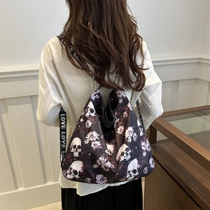 Minimalist black nylon crossbody bag featuring skull and floral prints with LOVE wide strap