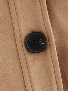 Detail of camel brown suede jacket featuring a high-quality black four-hole resin button
