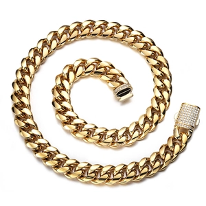 Close-up of golden stainless steel Cuban chain necklace with sparkling crystal encrusted clasp