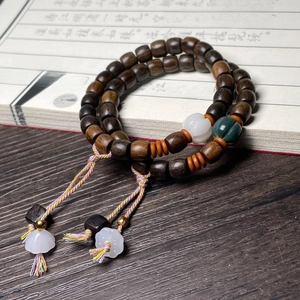 Zen style dark wood bead bracelet with white Bodhi and green pumpkin charms