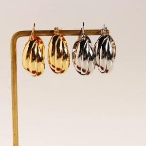 Modern triple layered crossover hoop earrings in gold and silver finish with metal texture