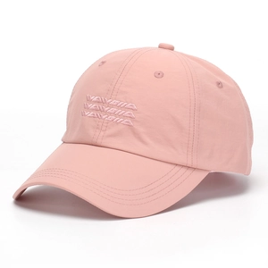 Detail of pink embroidered letters on a quick-dry baseball cap with a wide brim