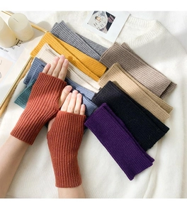 Detail of ribbed knit fingerless gloves in multiple colors for winter warmth