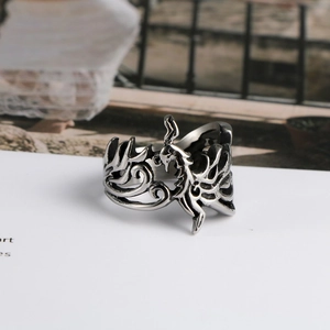 Macro detail of retro phoenix carving on silver stainless steel ring with relief textures