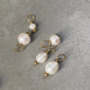 Detailed view of baroque pearl pendants with 14K gold-plated titanium steel loops
