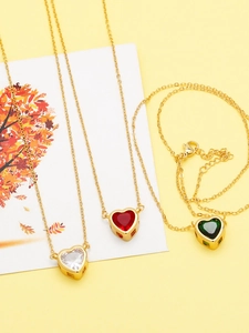 Detailed close-up of heart pendants in white, red, and green with golden metal edges