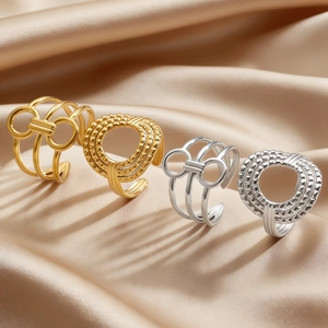 Detailed macro view of gold and silver irregular geometric open rings on silk fabric