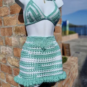 Detail view of handmade crochet bikini set featuring mint green and white stripes