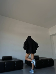 Oversized black hoodie back view showing wide silhouette and high-quality knit cotton fabric