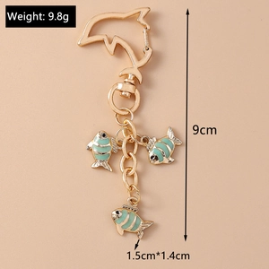 Detail view of dolphin hook keychain with mint green fish pendants and dimensions 9cm length
