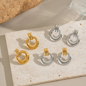 Three pairs of geometric hollow circular earrings in gold and silver finish set