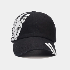 Detail of black cotton baseball cap with white VIBRA graffiti print and distressed brim
