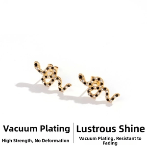 Macro shot of gold snake earrings with pavé-set black and white cubic zirconia crystals