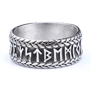 Close-up of Nordic rune carvings and woven relief on the stainless steel ring