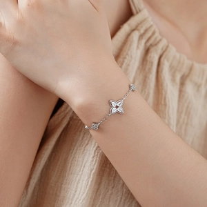 Close-up of silver-plated flower bracelet with sparkling zircons on female wrist