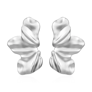 Macro shot of silver irregular petal earrings with glossy wavy texture on white background