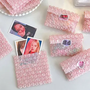 Detail of pink heart-shaped bubble wrap protector for photo cards with waterproof texture