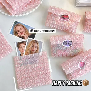 Detail of pink heart-shaped bubble wrap protector for photo cards with waterproof texture