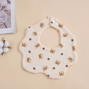 Close-up of 6-layer cotton gauze baby bib with cartoon tiger print and snap buttons