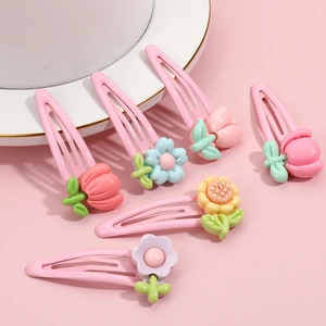 Set of six colorful flower hair clips for girls in plastic resin on pink background