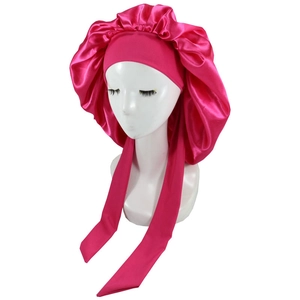 Detail of rose red satin bonnet with wide elastic headband and long decorative straps