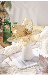 Close-up of sparkling artificial poinsettia flowers in a vase for Christmas decor
