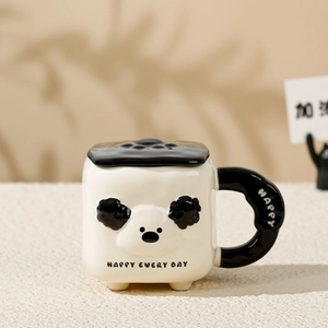 Close-up of a panda-shaped ceramic mug with black handle and Happy Every Day text