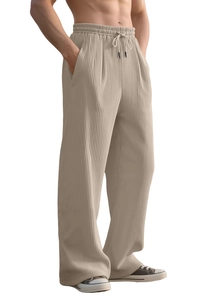 Detail of beige corduroy wide leg pants featuring drawstring waist and ribbed texture