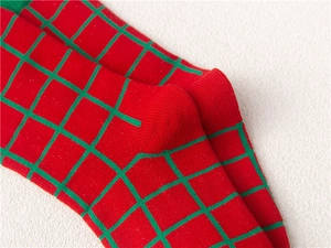 Christmas children's socks featuring festive red and green plaid knit texture detail