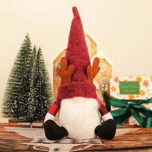 Nordic Christmas gnome with reindeer antlers and plaid sleeves for festive home decor
