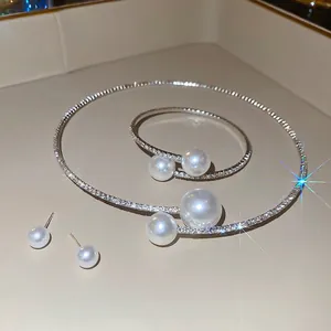 Elegant silver jewelry set with pearls and diamonds including necklace, bracelet and earrings