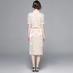 Elegant champagne gold satin qipao-style set with floral embroidery and tassel details