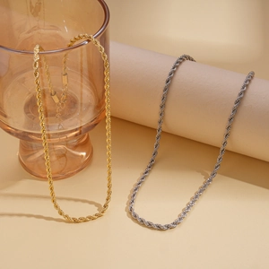 Close-up of gold and silver rope chain necklaces with detailed twisted metal texture